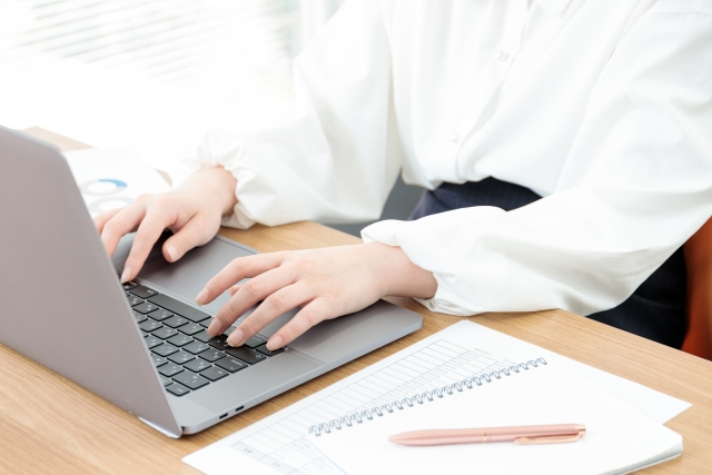 woman-typing-laptop-office-desk