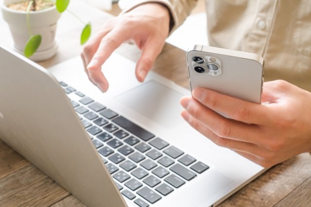 man-using-laptop-and-iphone