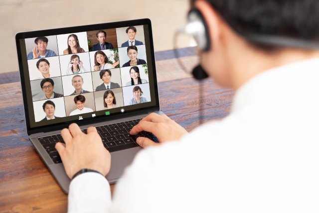 man-video-conference-headset-laptop