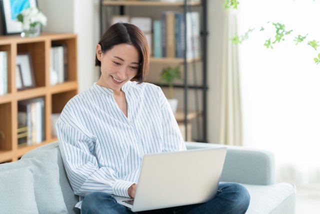 woman-laptop-sofa-smiling-casual